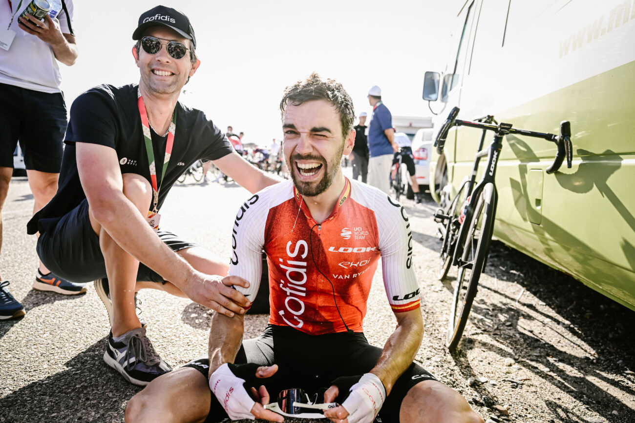A cyclist celebrates with his soigneur after winning a race.