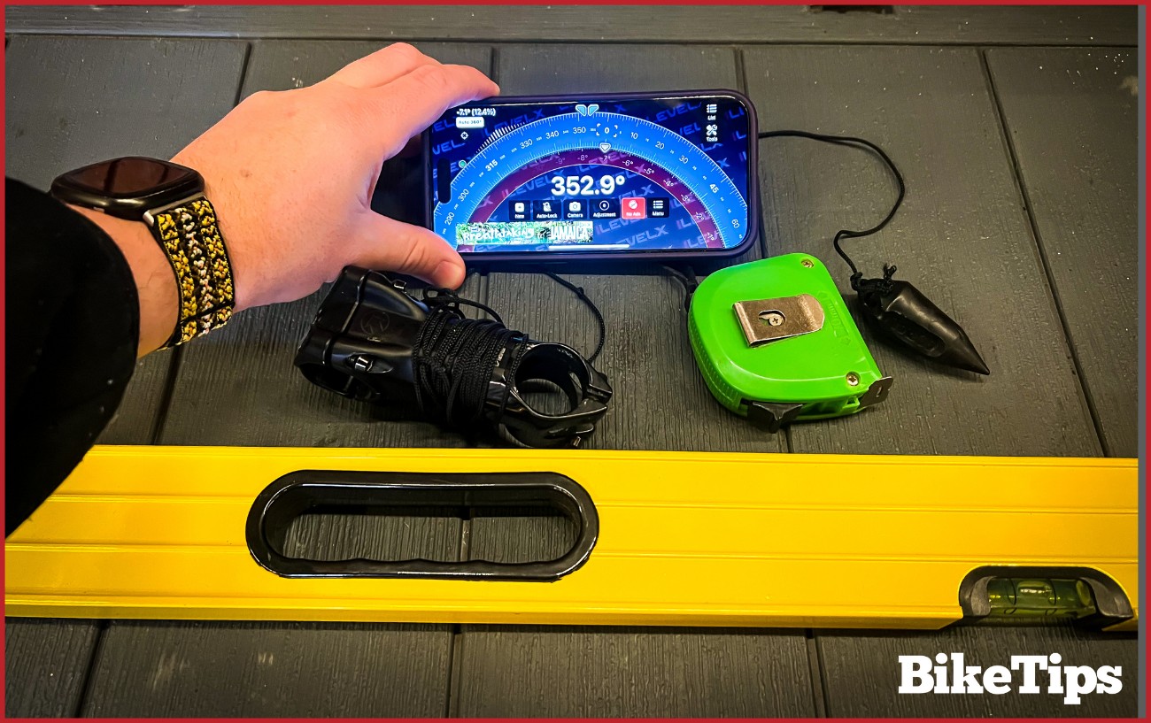 The tools required in learning how to measure a bike frame. A Clinometer, straight level, a measuring tape, and a plumb line.
