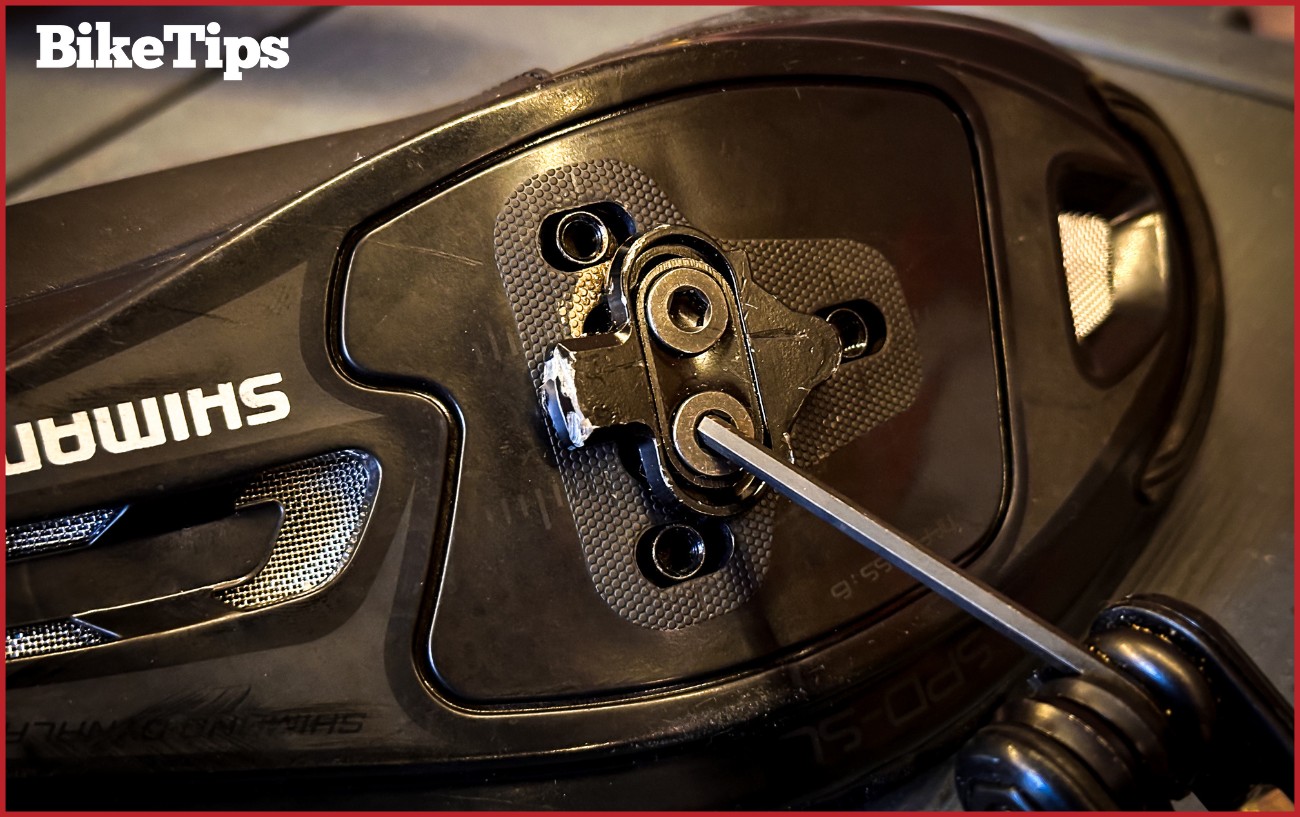 Unscrewing cleats on a SPD cycling shoe.