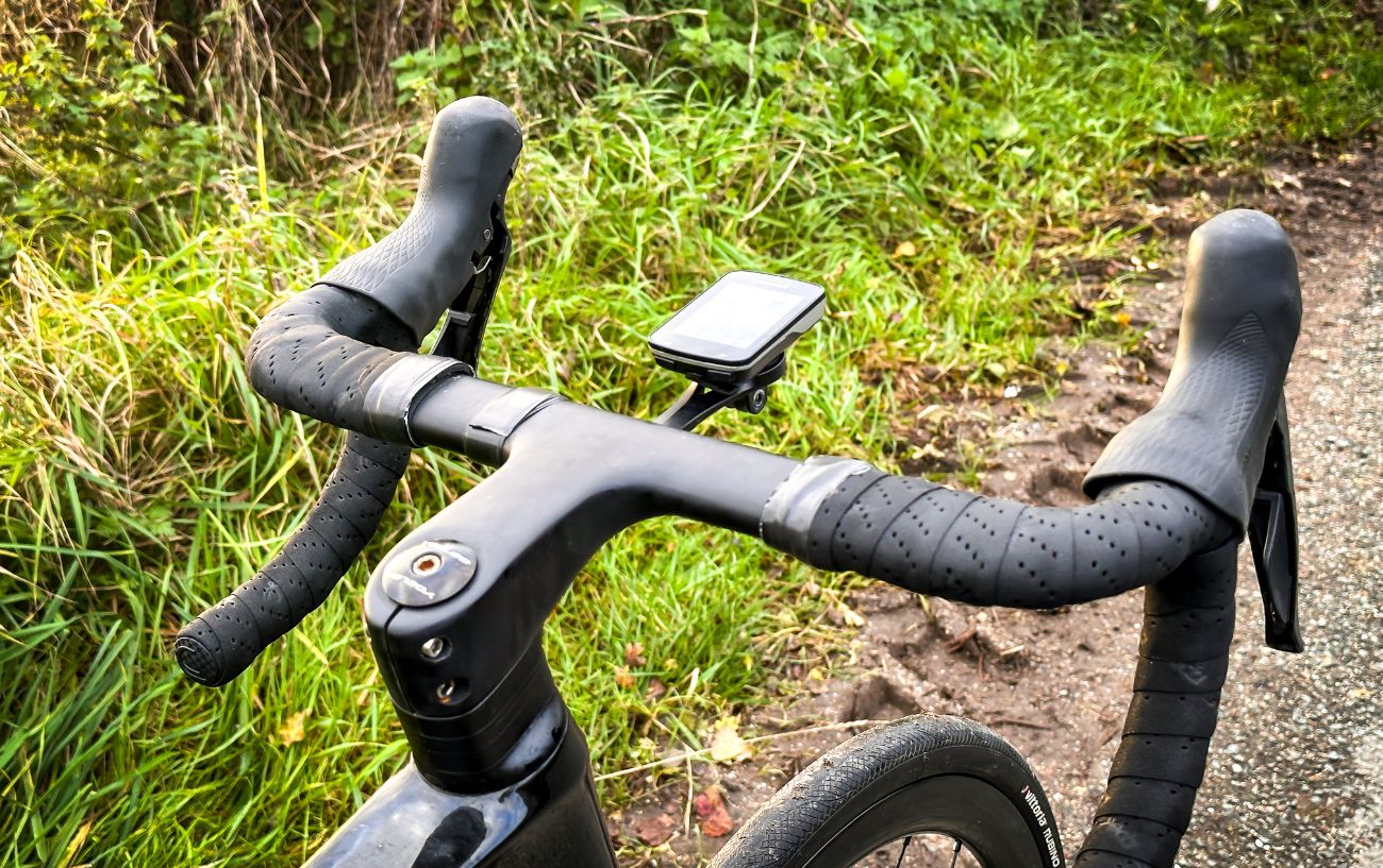 A black road bike handlebar with bar tape.
