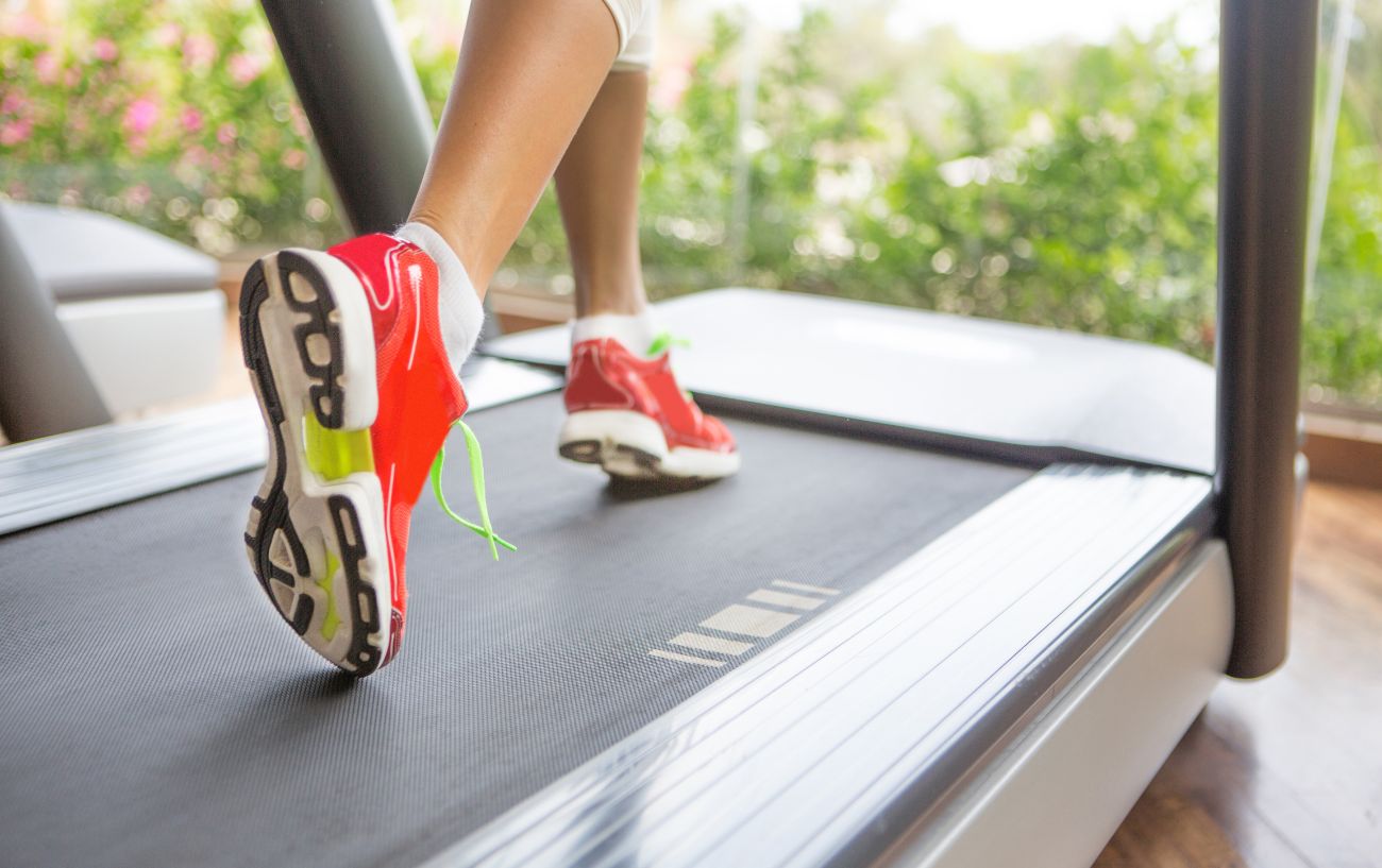 Running on a treadmill in red shoes.