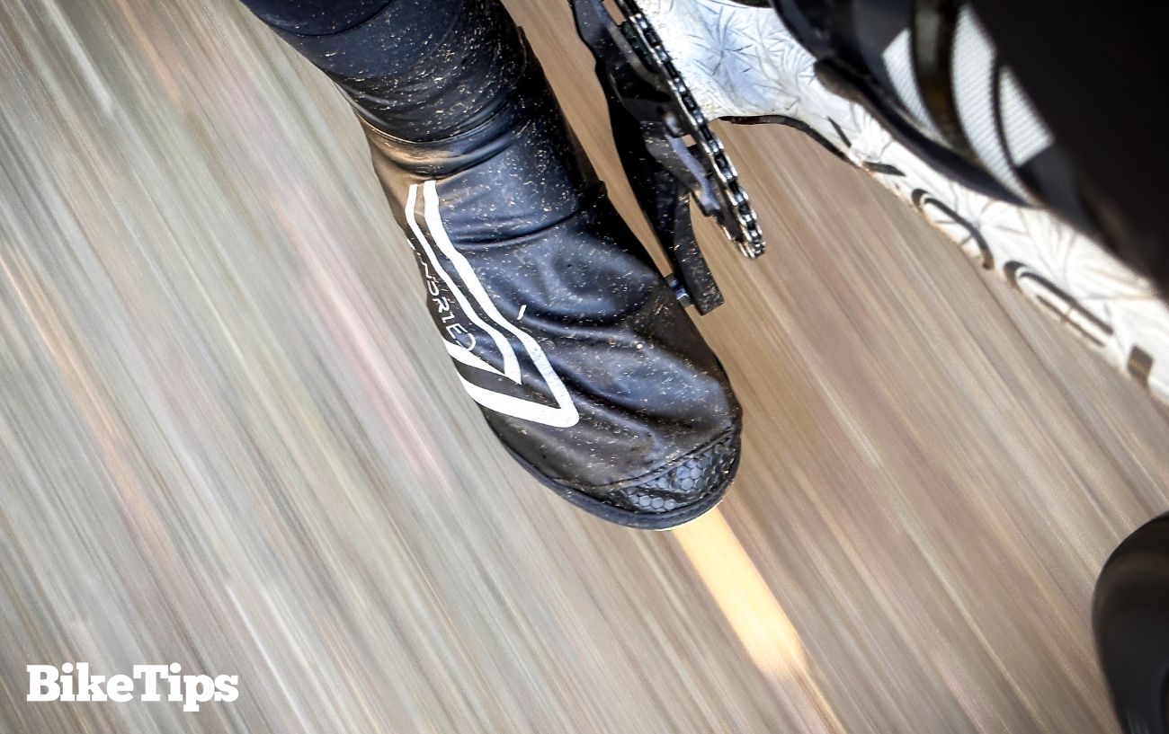 A bicycle pedal and foot pedalling the bike.