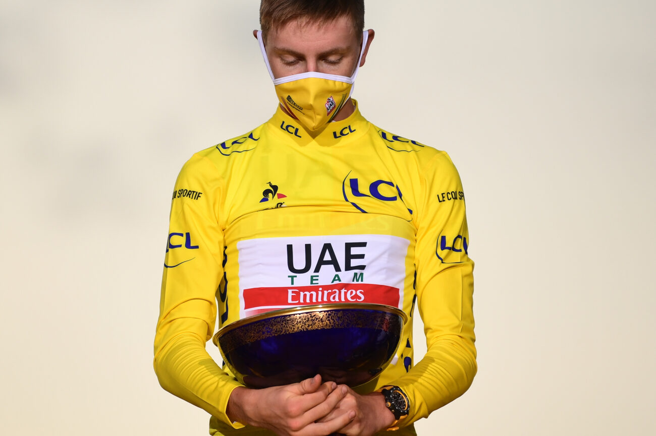 Tadej Pogacar holds the 2021 Tour de France trophy.