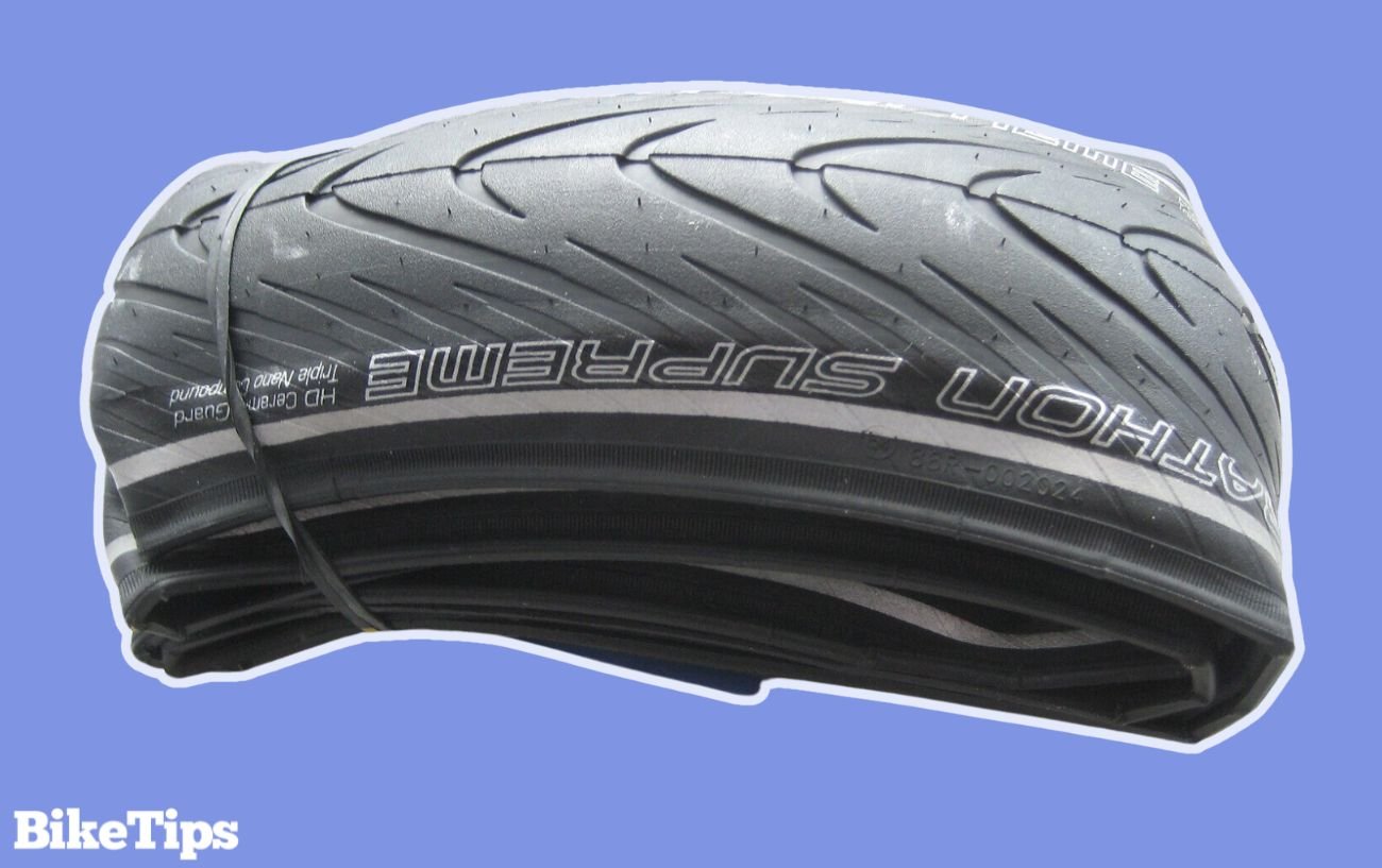 Photo of a folded bike tire on a purple background.