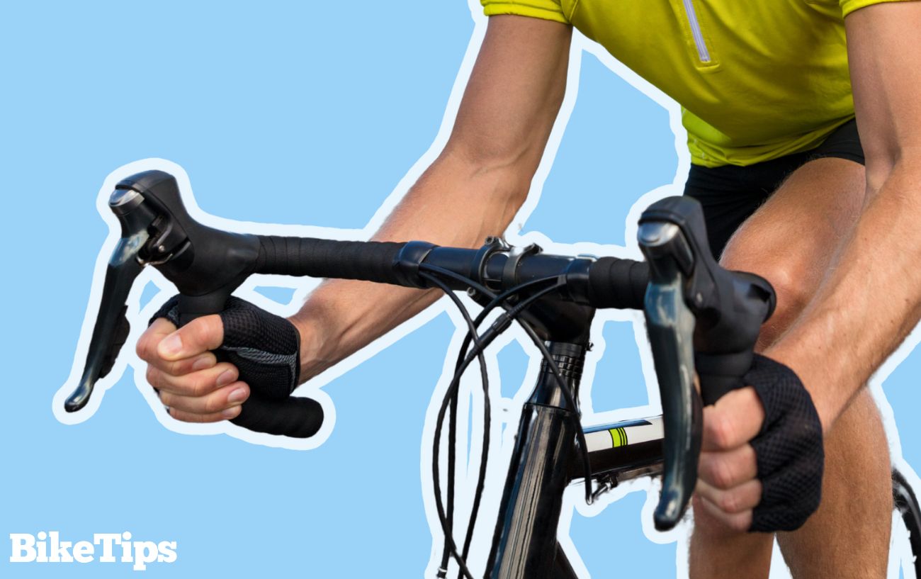 Road bike handlebars on a blue background.