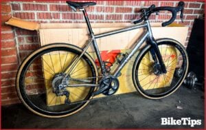 How to assemble a bike, showing an assembled grey road bike next to a bike box.