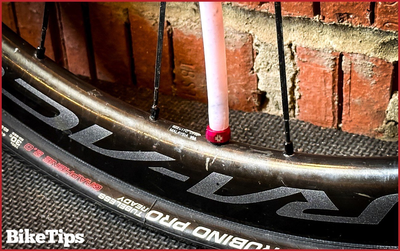 Inserting sealant into a tubeless tire.