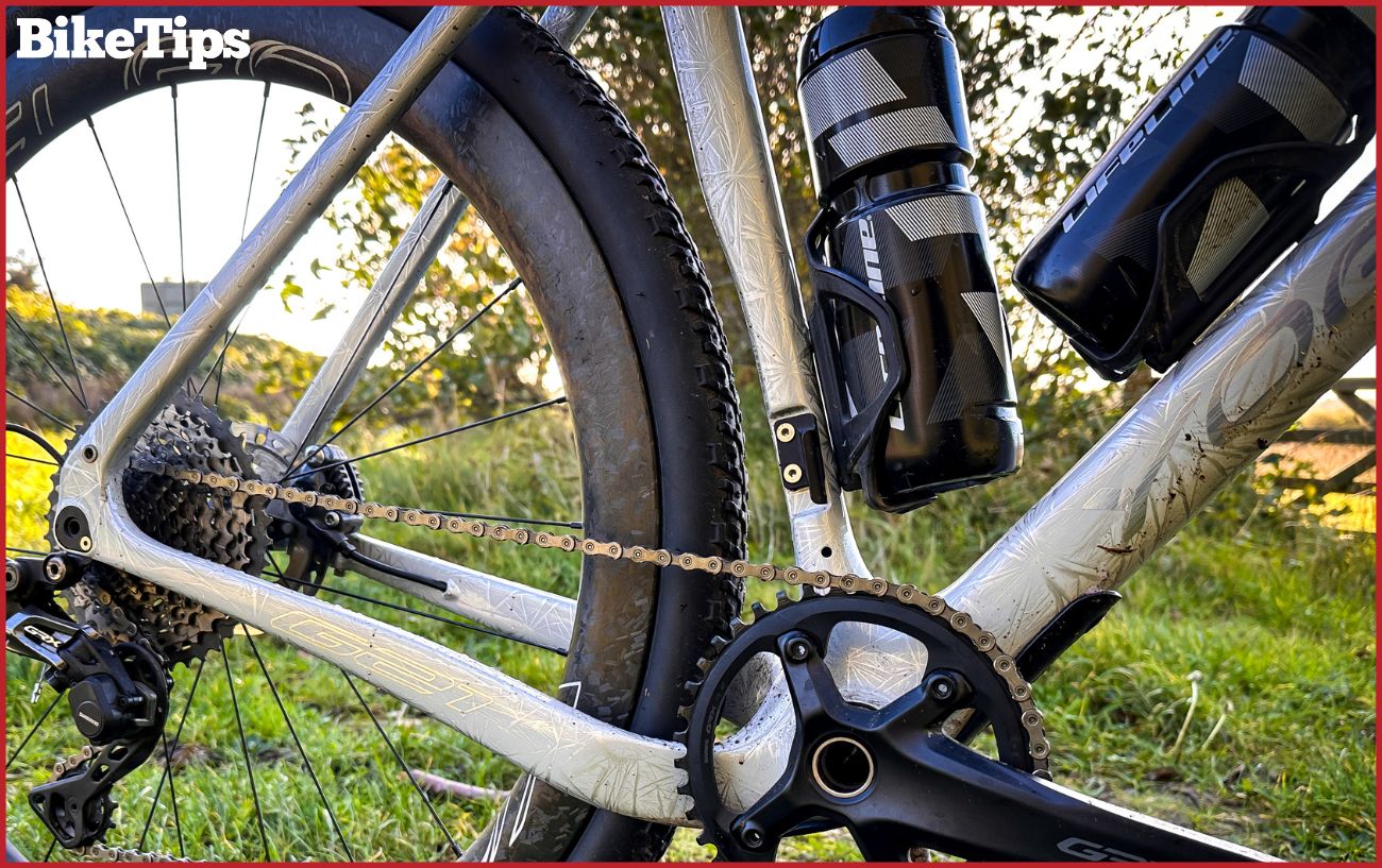 Tire clearance to the seat tube shown on a white gravel bike.