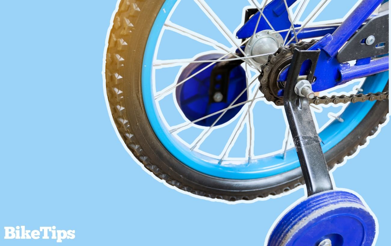 A child's bike with training wheels on a blue background.